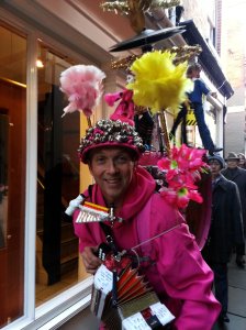 A gentleman nicknamed "The Orchestra man" plays during a street performance for kids