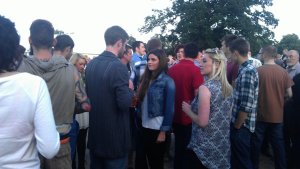 A group of young visitors waiting for the music tent to re-open