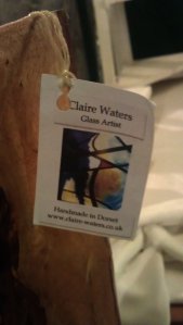 Claire Water's card attached to one of her artworks