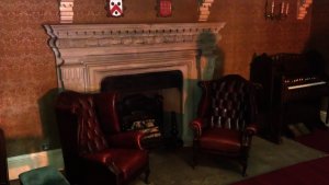 Fire place and two Victorian chairs placed in the middle of the staircase - perfect observation point 