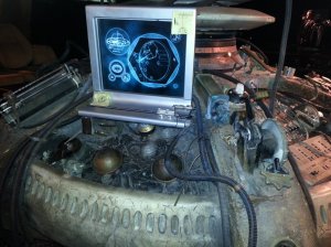 Console close up with  computer read screen (in Gallifreyan)