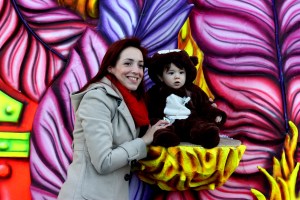 Family affair - mother poses with her son against a carnival float