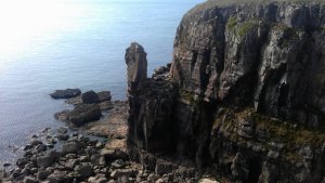 Beach below with a sharp rock knowns as The Beacon or The Lighthouse