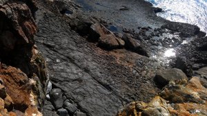 Cracked stone surface crates mini lakes and rock pools